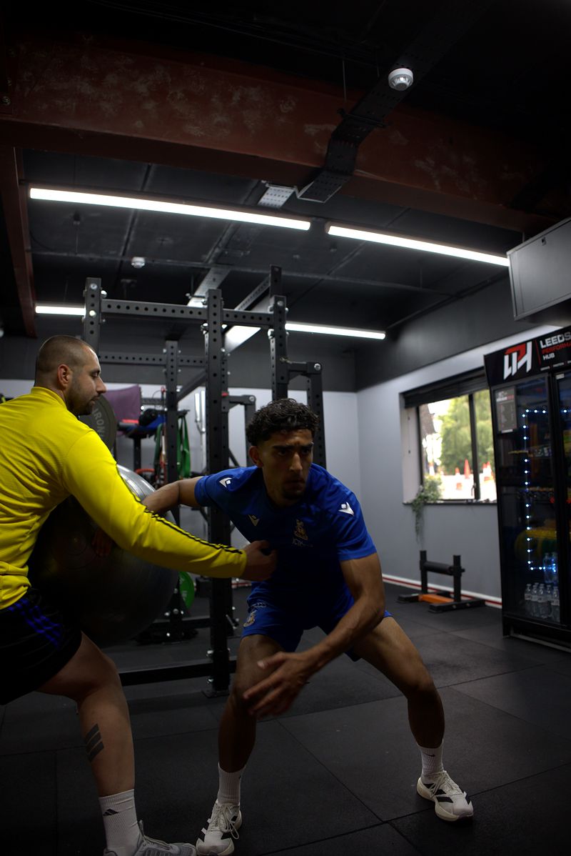 Hassan Ayub working with Dion Tsolakis on the gym floor