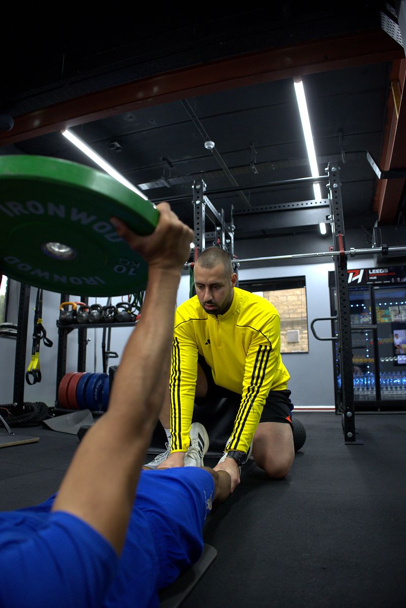 Hassan Ayub stretching with Dion Tsolakis